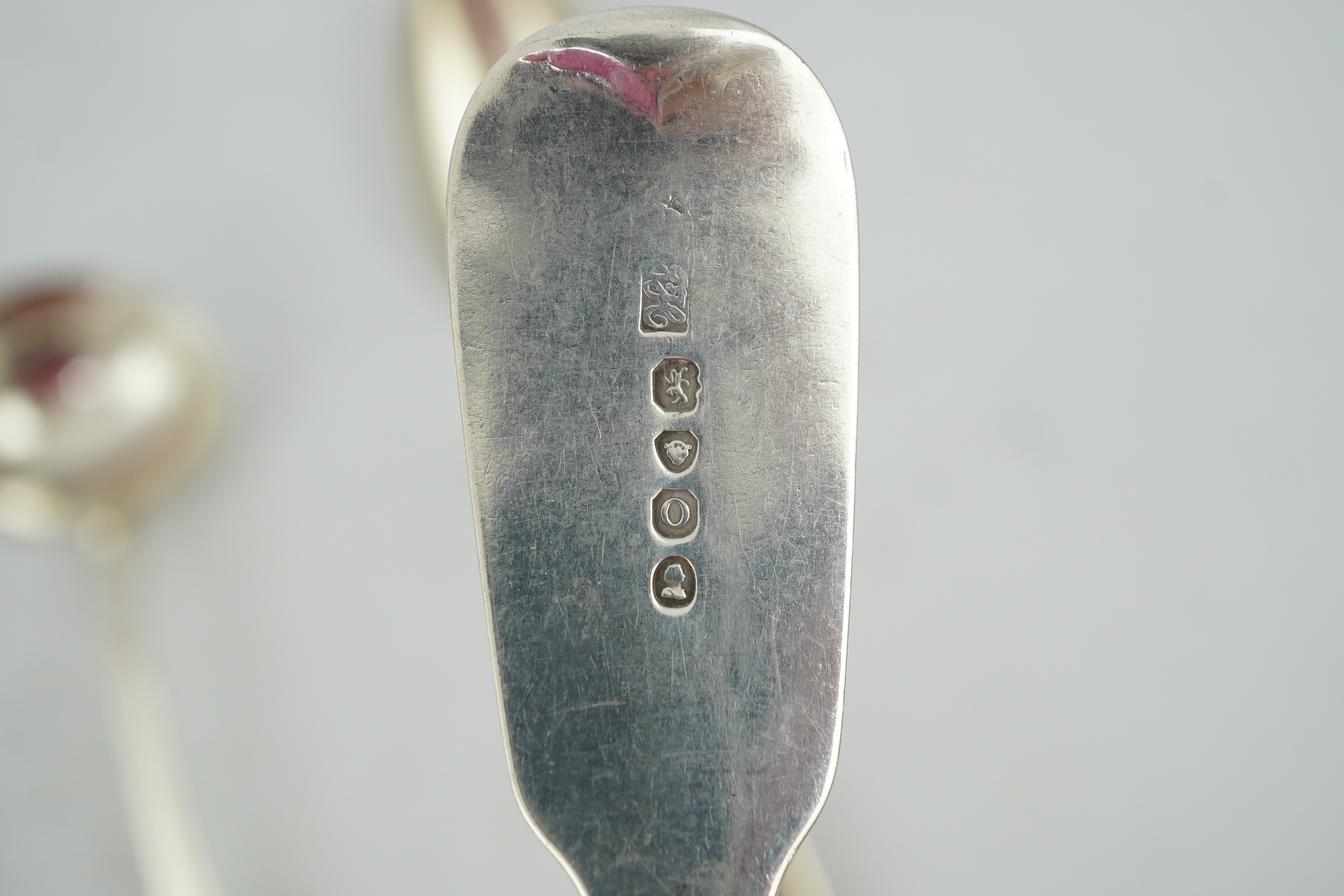 A matched set of seven late Victorian silver table spoons by Goldsmiths & Silversmiths Co Ltd (5) and Francis Higgins (2), London, 1894, together with a similar silver sauce ladle, two earlier silver table spoons and a W